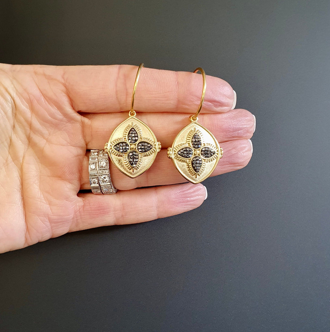 Gold Titanium Stud Hoop Earrings With Hematite Four Leaf Clover Charms, March And April Birthstone Jewellery